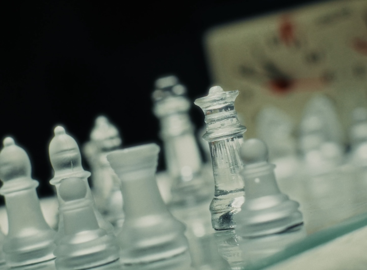 Rohan poised over a glass chessboard